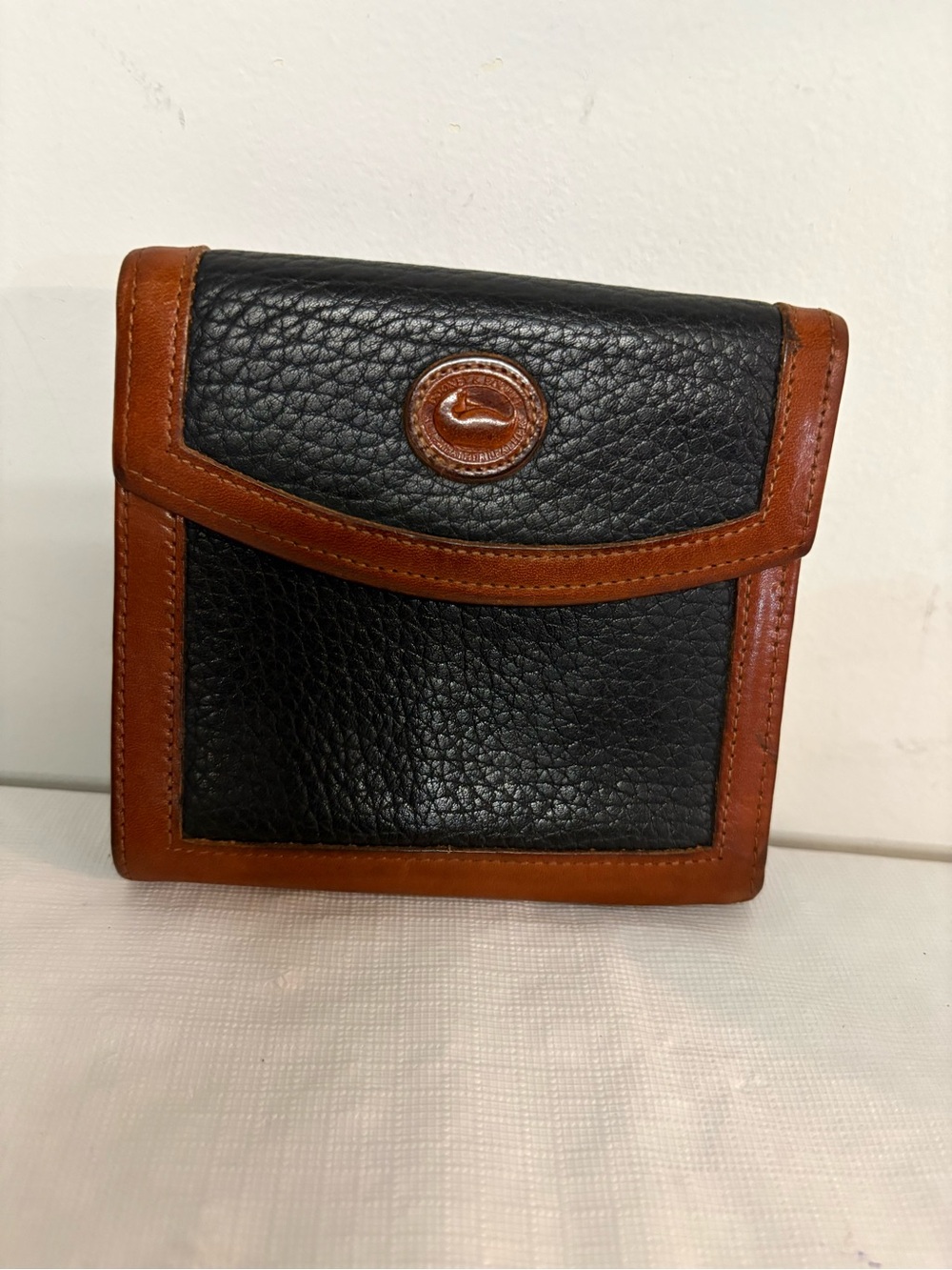 Dooney & Bourke Black and Brown Pebbled Leather Bi-Fold Wallet